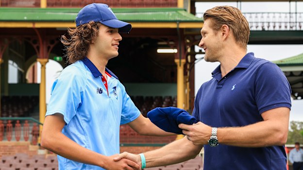 Partnership: Sam Konstas receives his NSW cap before his Shield debut last year.