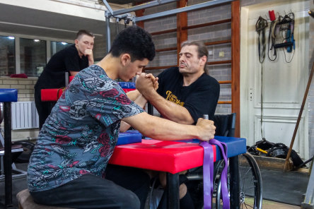 Long way from home: Australian Simon Appleby, right, pictured in Samarkand, Uzbekistan, is training with Uzbekistan arm-wrestlers in the lead up to the world championships in Moldova this month.