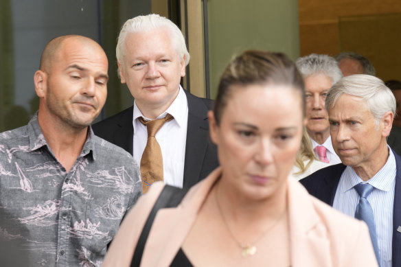 Julian Assange leaving the Saipan court.