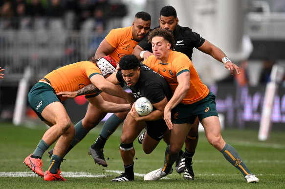 All Blacks winger Leicester Fainga’anuku takes on the Wallabies’ defence.