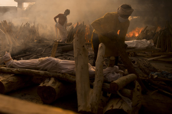 A priest prepares to perform the last rites of a patient who died of COVID-19 during a mass cremation at a crematorium on May 01, 2021 in New Delhi, India. 