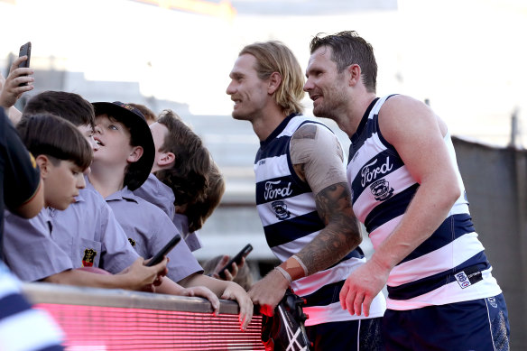 Tom Stewart and Patrick Dangerfield greet fans.