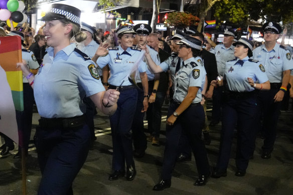 NSW Police Commissioner Karen Webb (centre) marches with colleagues in the 2023 Mardi Gras parade.