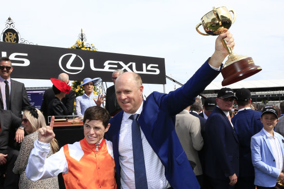 Danny O'Brien holds the Melbourne Cup with Craig Williams after winning with Vow And Declare.