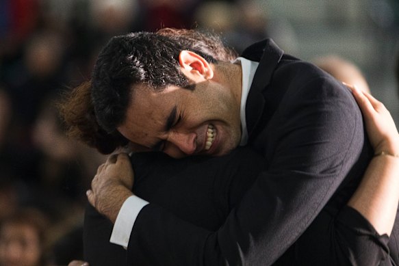 Members of the Iranian community console each other during a memorial for victims of the Ukrainian Airlines tragedy.