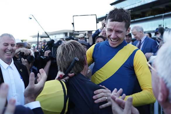 Bjorn Baker lifts jockey Jason Coillett after their Doncaster Mile win.