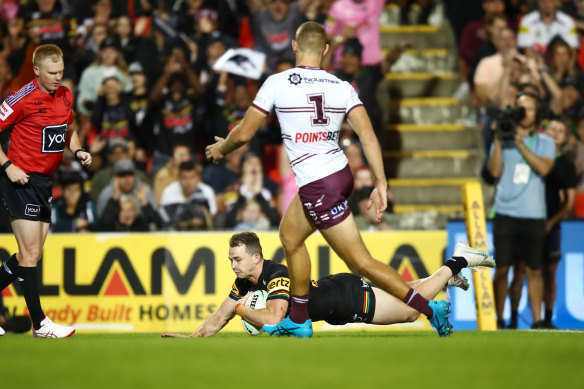Dylan Edwards dives over for his second try as Tom Trbojevic looks on.