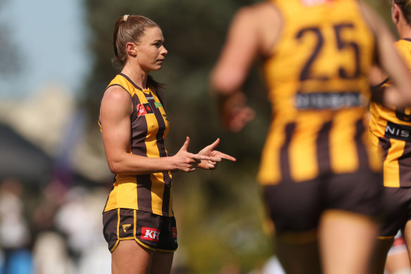 Aileen Gilroy of the Hawks celebrates kicking a goal against the Magpies.