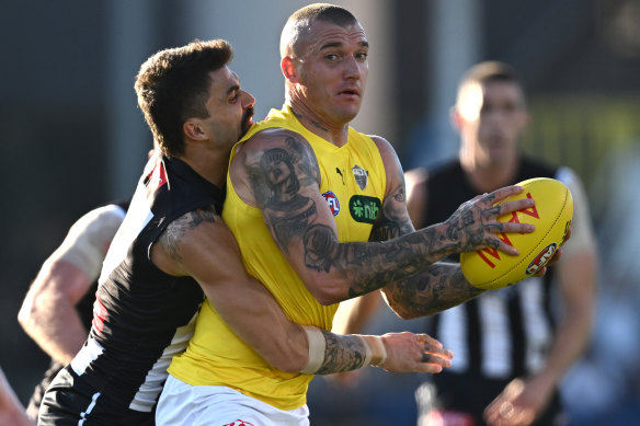 Dustin Martin is tackled by Oleg Markov  in last week’s practice match against Collingwood.