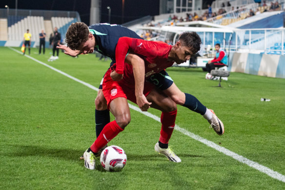 Bahrain’s Mohamed Adel and Australia’s Jordan Jacob Bos fight for the ball.