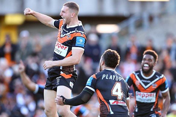 A jubilant Adam Doueihi and Tigers teammates celebrate his match-winning field goal.