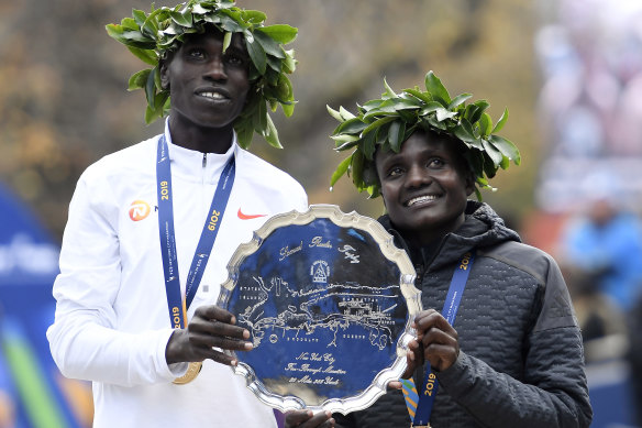 Geoffrey Kamworor and Joyciline Jepkosgei of Kenya pose with the trophy after winning the Mens' and Womens' Division of the 2019 TCS New York City. 