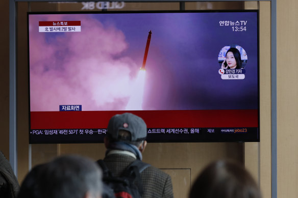 People in Seoul watch a news program reporting that North Korea had fired two projectiles on Monday.