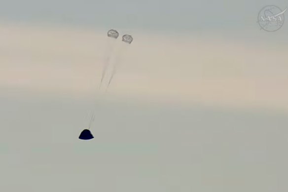 The Orion spacecraft’s crew capsule, named Integrity, deploys its first parachutes.