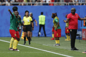 Cameroon's Ajara Nchout points head coach Alain Djeumfa to the big screen after a controversial VAR decision.