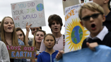 Greta Thunberg, centre in blue, joins other young climate activists Friday for a climate strike outside the White House in Washington on Friday.