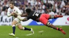 England’s Ben Earl, left, is tackled by Fiji’s Viliame Mata.