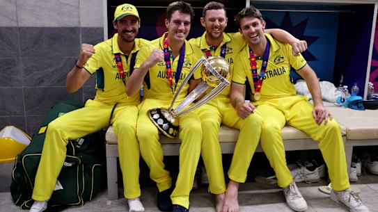 Mitchell Starc, Pat Cummins, Josh Hazlewood and Mitch Marsh of Australia pose with the World Cup trophy.
