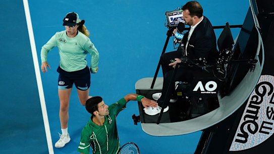Novak Djokovic taps the chair umpire's foot during the Australian Open final.
