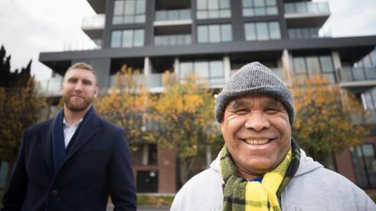 Armindo De Olizeara (right) outside his new home, in a social housing development in Footscray, with Unison acting CEO James King.