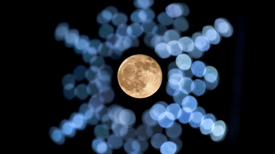 The rising moon, framed by Christmas lights in southern Missouri in the US on November 30.