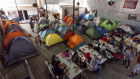 Migrants eat at a shelter set up in Mexico near the US border.
