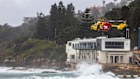The Westpac Rescue helicopter flies low to search waters off Coogee Beach.