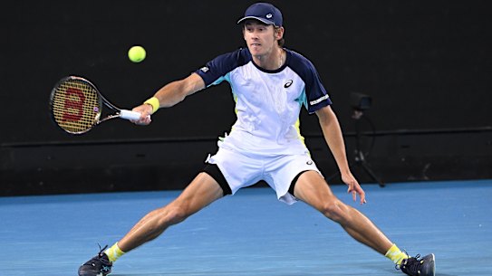 MELBOURNE, AUSTRALIA - JANUARY 18: Alex De Minaur of Australia plays a forehand in his first round singles match against Lorenzo Musetti of Italy during day two of the 2022 Australian Open at Melbourne Park on January 18, 2022 in Melbourne, Australia. (Photo by Quinn Rooney/Getty Images)