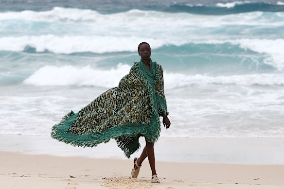 A model walks the beach “runway” during the COMMAS show held as part of Australian Fashion Week 2026 at Tamarama Beach in Sydney. 