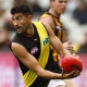 ELBOURNE, AUSTRALIA - MAY 14: Marlion Pickett of the Tigers
 runs with the ball during the round nine AFL match between the Hawthorn Hawks and the Richmond Tigers at Melbourne Cricket Ground on May 14, 2022 in Melbourne, Australia. (Photo by Darrian Traynor/AFL Photos/via Getty 