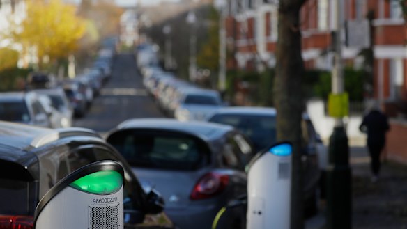 Build back greener: an electric car charges on a street charging port in London.