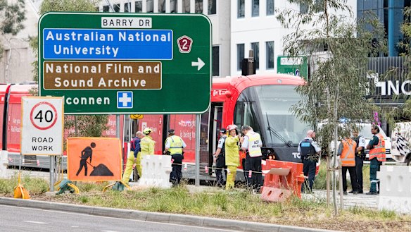 Emergency services at the scene of a collision between a tram and a pedestrian in Canberra on Saturday morning.