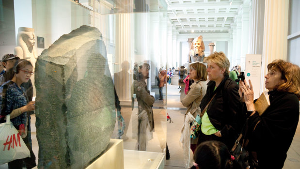 British Museum visitors view  the Rosetta Stone in London.