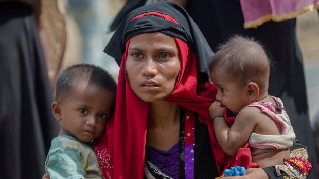 Rohingya Muslim woman, Rukaya Begum, who crossed over from Myanmar into Bangladesh, holds her son Mahbubur Rehman, left and her daughter Rehana Bibi.