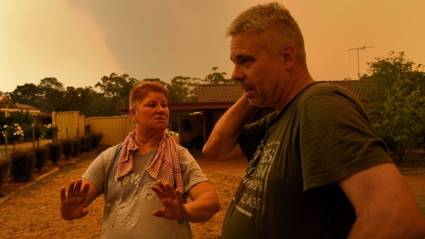 Sandy and Brian Castle monitor the situation at their home on Yanderra Road.