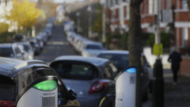 Build back greener: an electric car charges on a street charging port in London.