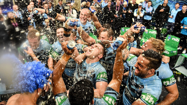 Party time: NSW players celebrate in the sheds after the match.  