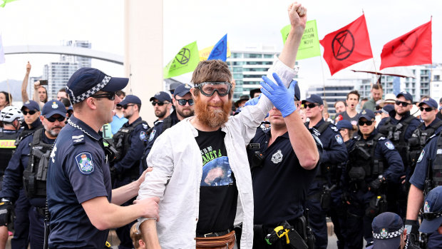 Police arrest activists from the Extinction Rebellion group after they took over the William Jolly Bridge on October 11.