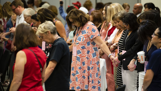 Attendees pray during the Women For Trump campaign event.