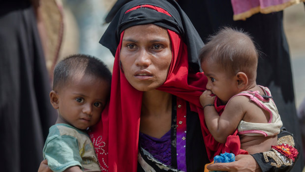 Rohingya Muslim woman, Rukaya Begum, who crossed over from Myanmar into Bangladesh, holds her son Mahbubur Rehman, left and her daughter Rehana Bibi.