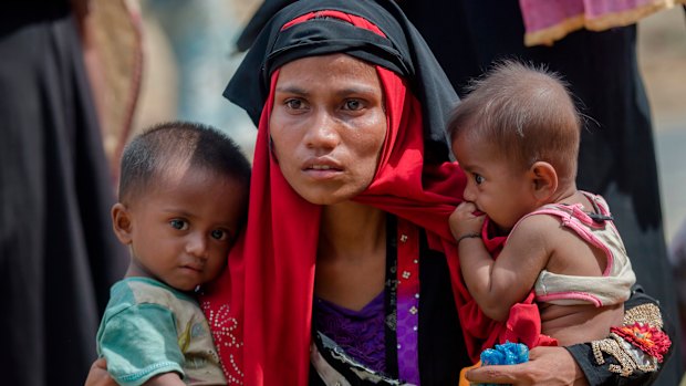 Rohingya Muslim woman, Rukaya Begum, who crossed over from Myanmar into Bangladesh, holds her son Mahbubur Rehman, left and her daughter Rehana Bibi.