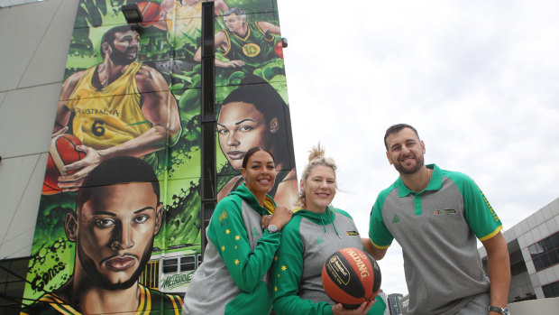 Liz Cambage, Lauren Jackson and Andrew Bogut pose in front of the Marvel Stadium mural.