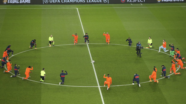 PSG and Basaksehir players take a knee before kick-off in the match which was suspended Tuesday following an alleged racist slur from an official.