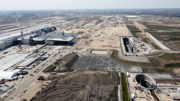 Construction continues on the Western Sydney Airport, but will its boost to the city’s west be undermined by the axing of other projects. 