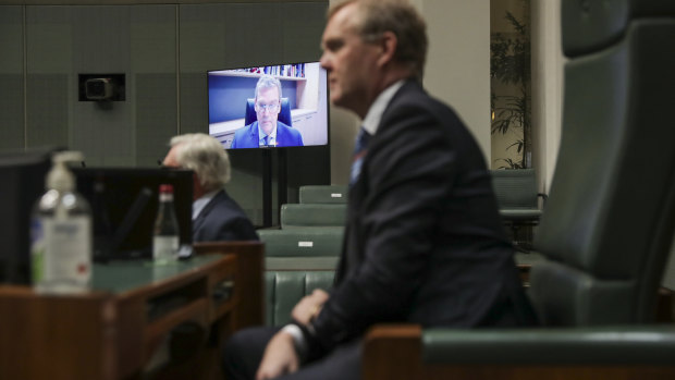 MP for Groom, John McVeigh, is seen on a screen as Speaker Tony Smith meets with the remote Parliament team. 