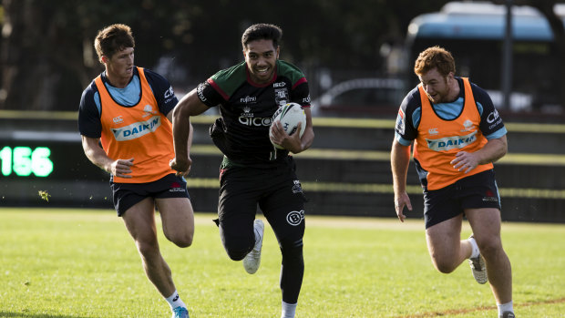 Waratahs players Alex Newsome and Harry Johnson-Holmes chase down Souths' Hymel Hunt at Redfern Oval. 