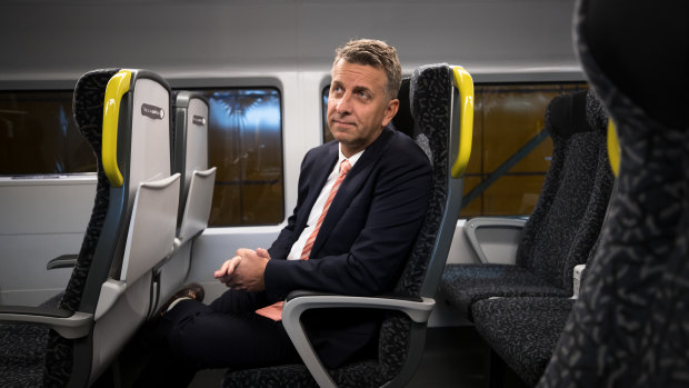 Transport Minister Andrew Constance says the fixed seats allow passengers to have features such as tray tables and charge points for mobile phones. 