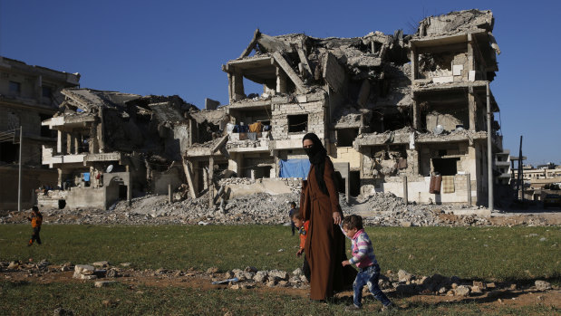 A Syrian woman with her children in Manbij, north Syria, On December 28,  Syria's military said it entered the flashpoint Kurdish-held town, where Turkey has threatened an offensive following the US surprise decision to withdraw troops from Syria. 