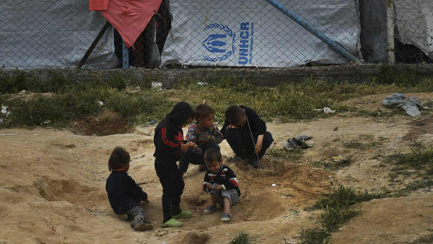 Disease trap: Children play in the dirt near the fence line of the foreign ISIS section of Al Hawl camp in Syria.