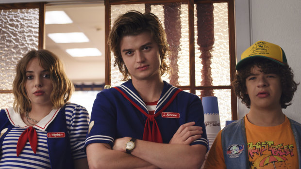 Full of chills: Steve Harrington (Joe Keery), centre, is working in an ice-cream shop with Robin (Maya Hawke), left, and mentoring Dustin (Gaten Matazrazzo), right.